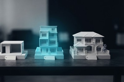 Three miniature buildings with price tags on a table: a small plain one, a cyan mid-sized tower and a large villa