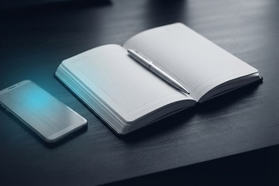 Founder's notebook with a numbered list of interview questions beside a phone mid-call