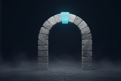 A freestanding stone arch of plain grey blocks in a dark hall, with a glowing cyan keystone at the top