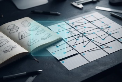An open notebook of product sketches beside index cards joined by connecting lines, with a translucent cyan panel between them