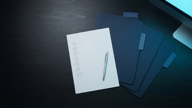 Founder comparing printed proposals from several agencies side by side on a desk