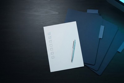 Founder comparing printed proposals from several agencies side by side on a desk